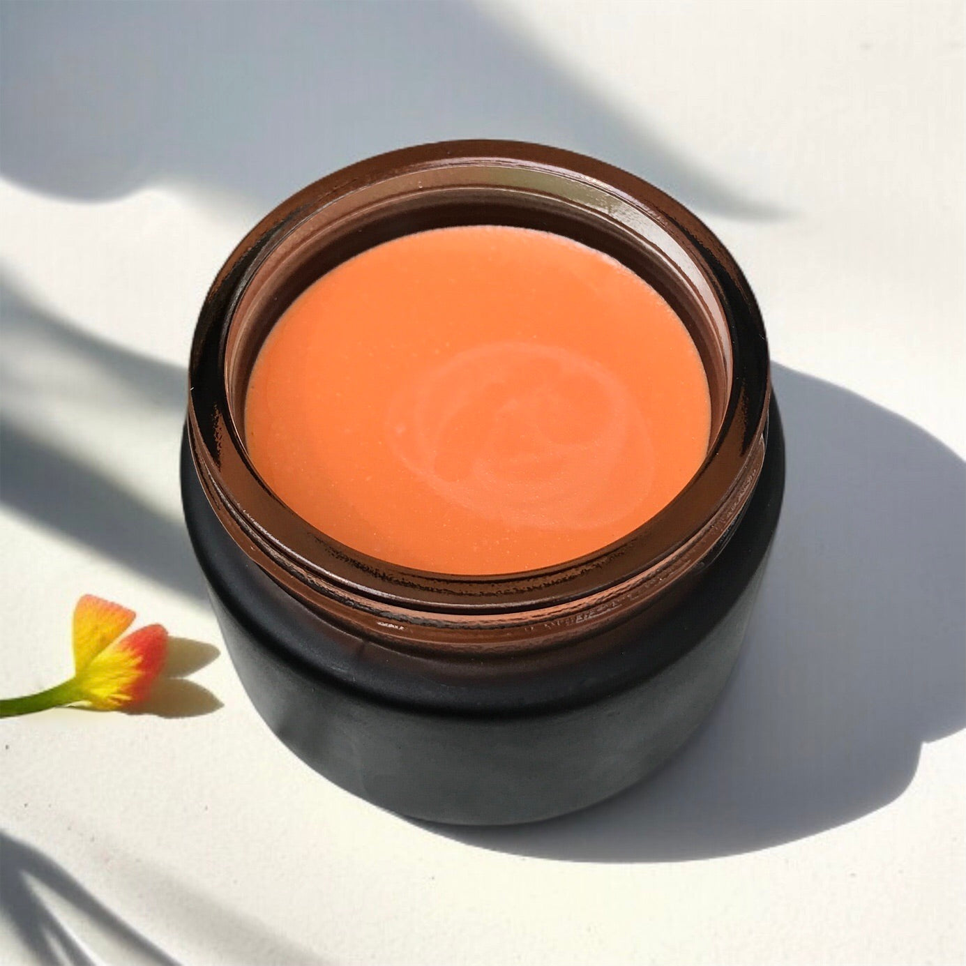 Hibiscus Glow Balm in a black jar