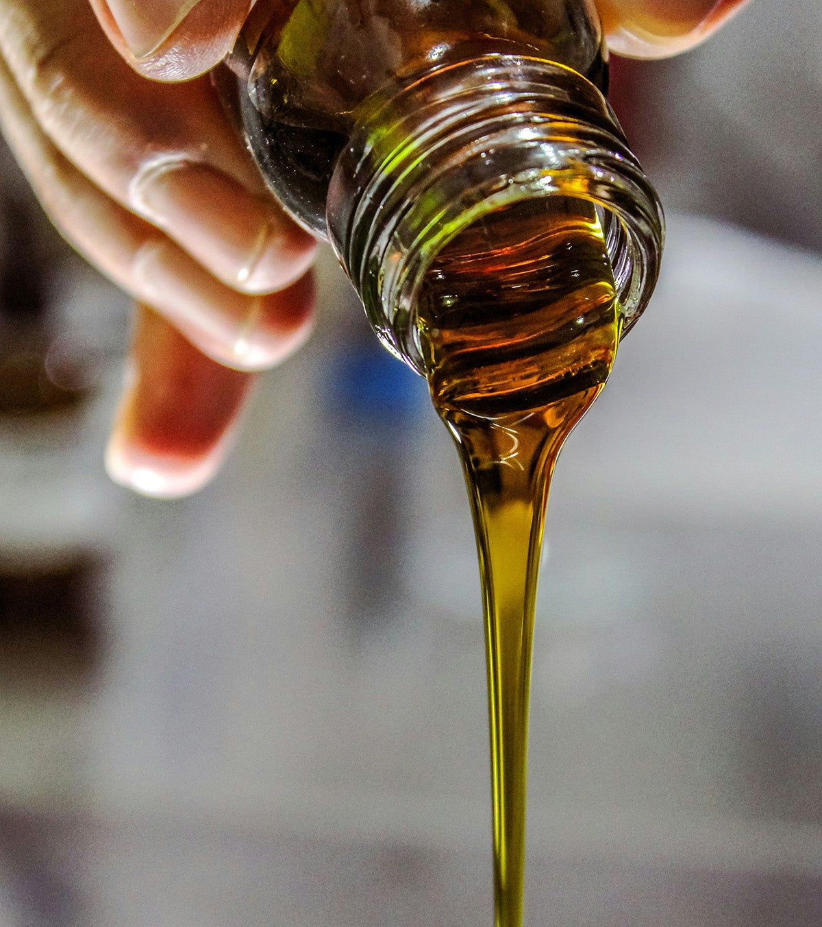 pouring oil out of glass bottle