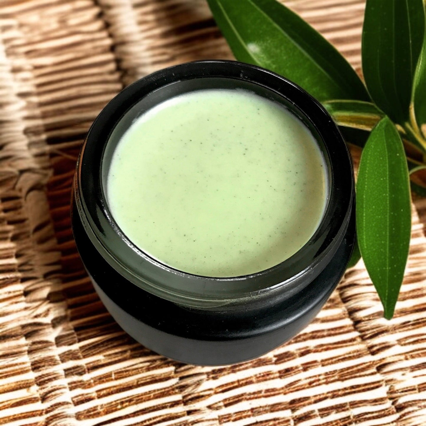close-up of matcha clear skin balm in black jar