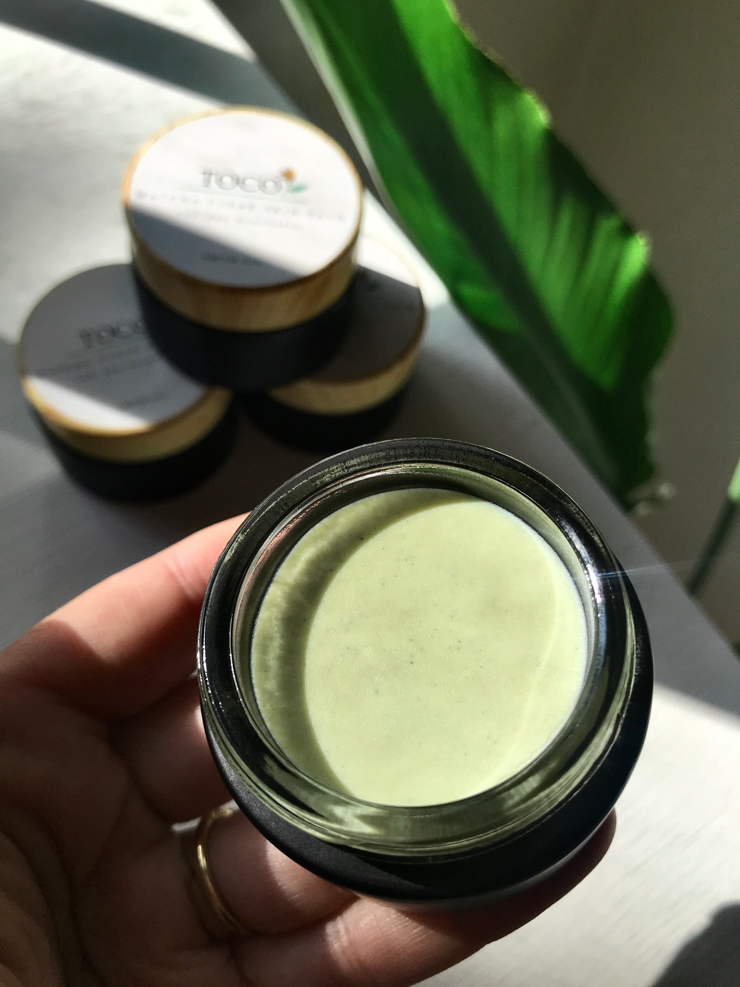 matcha clear skin balm in black jar in sunlight