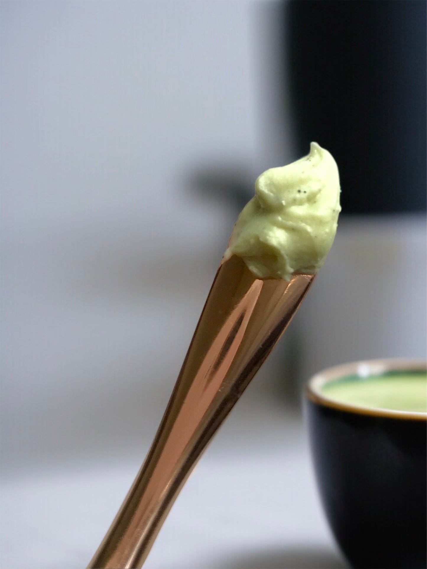 Matcha Clear Skin Balm on gold spoon