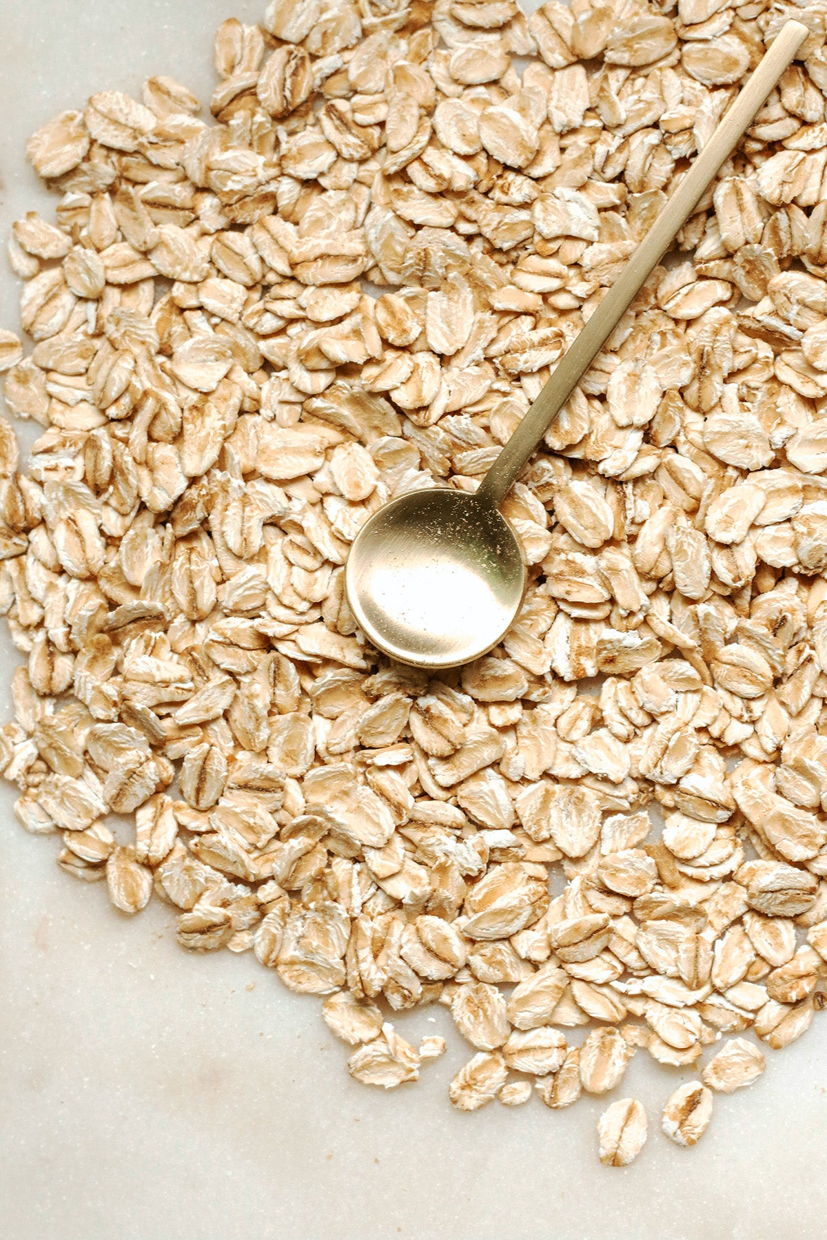 pile of oats and a gold spoon