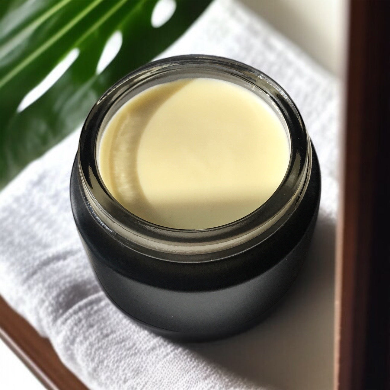 banana barrier cream in black glass jar 