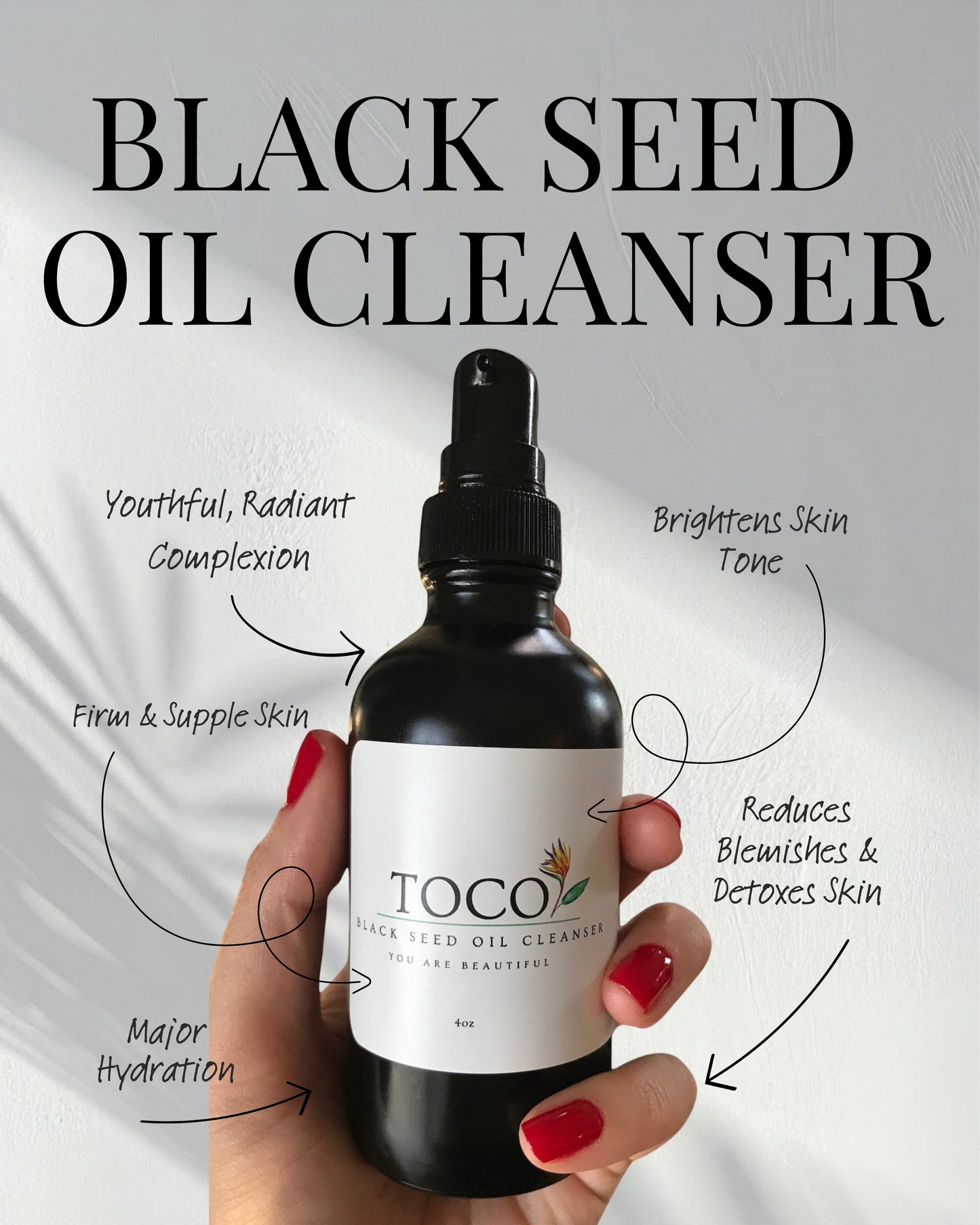 Bottle of Toco Black Seed Oil Cleanser held by a hand with text highlighting benefits on a light gray background