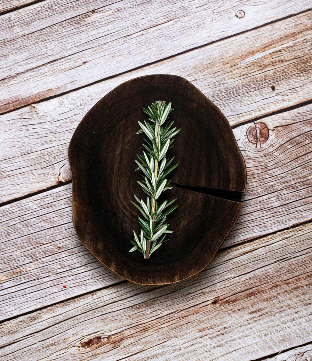 rosemary sprig on a piece of wood