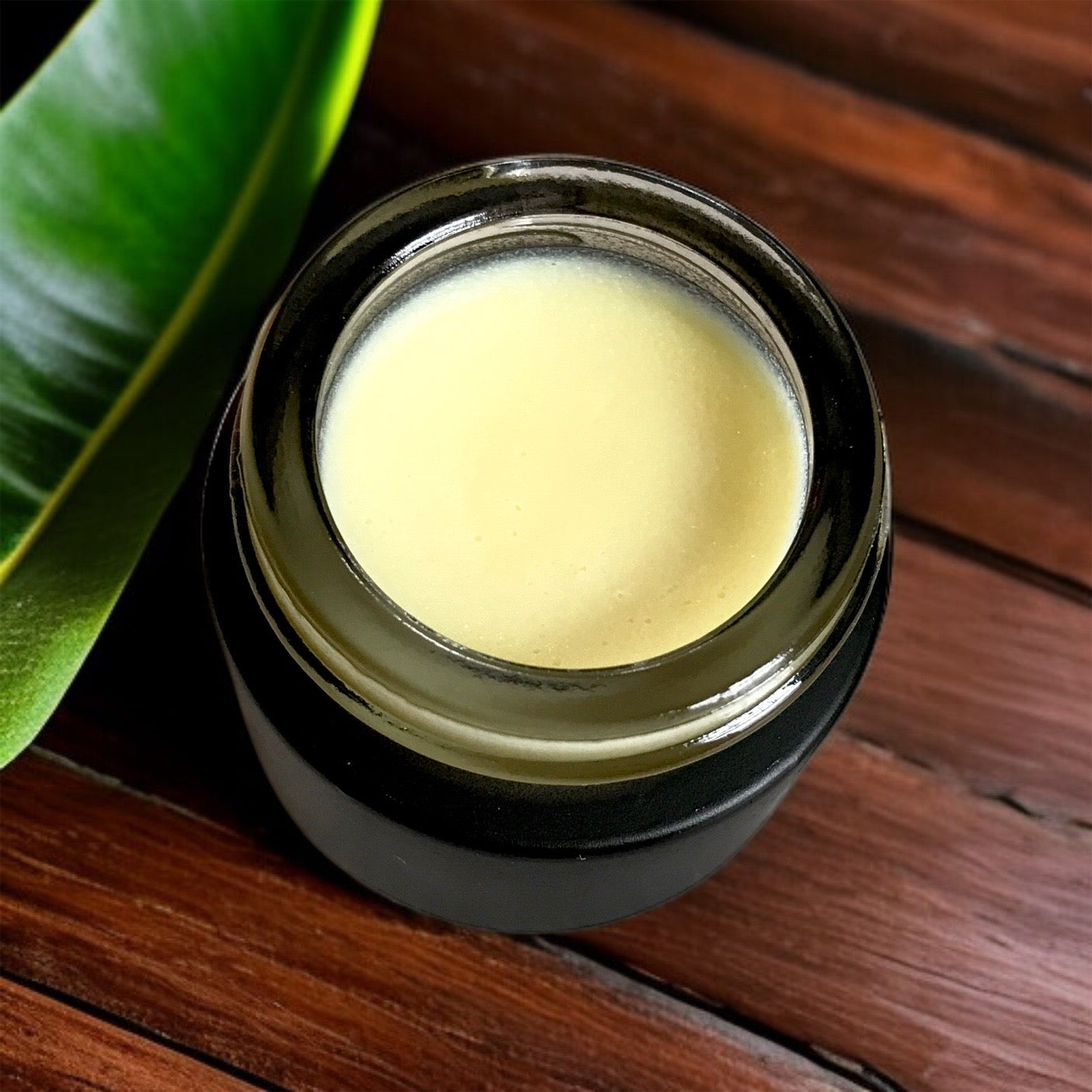 close-up of banana eye concentrate in 10g black glass jar