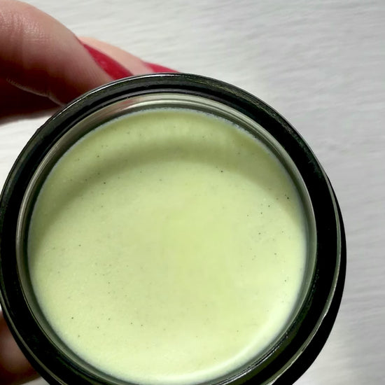 hand holding matcha clear skin balm