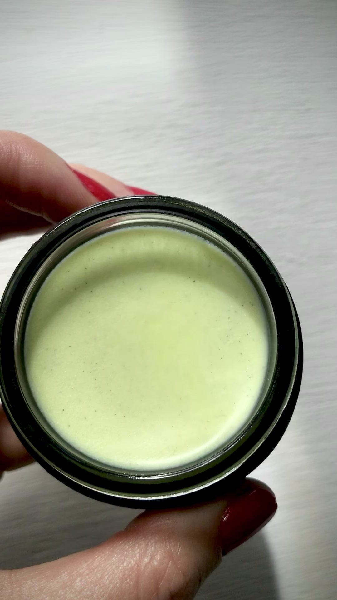 hand holding matcha clear skin balm