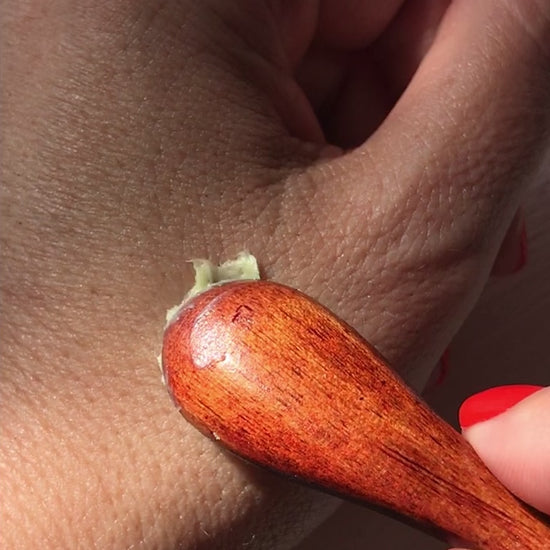 applying the matcha clear skin balm onto hand
