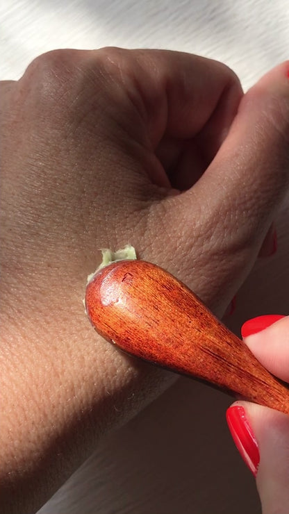 applying the matcha clear skin balm onto hand